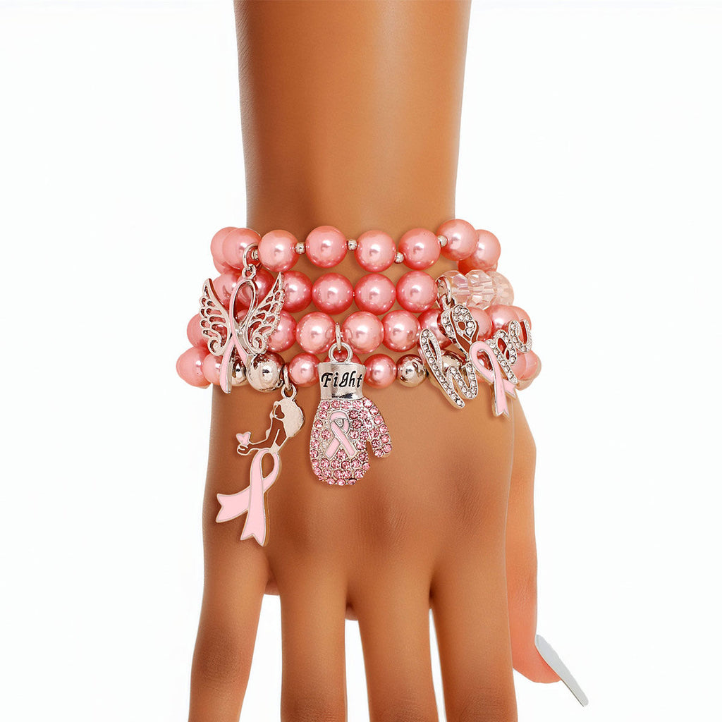Pink pearl bracelet with various charms on a mannequin wrist against a white background