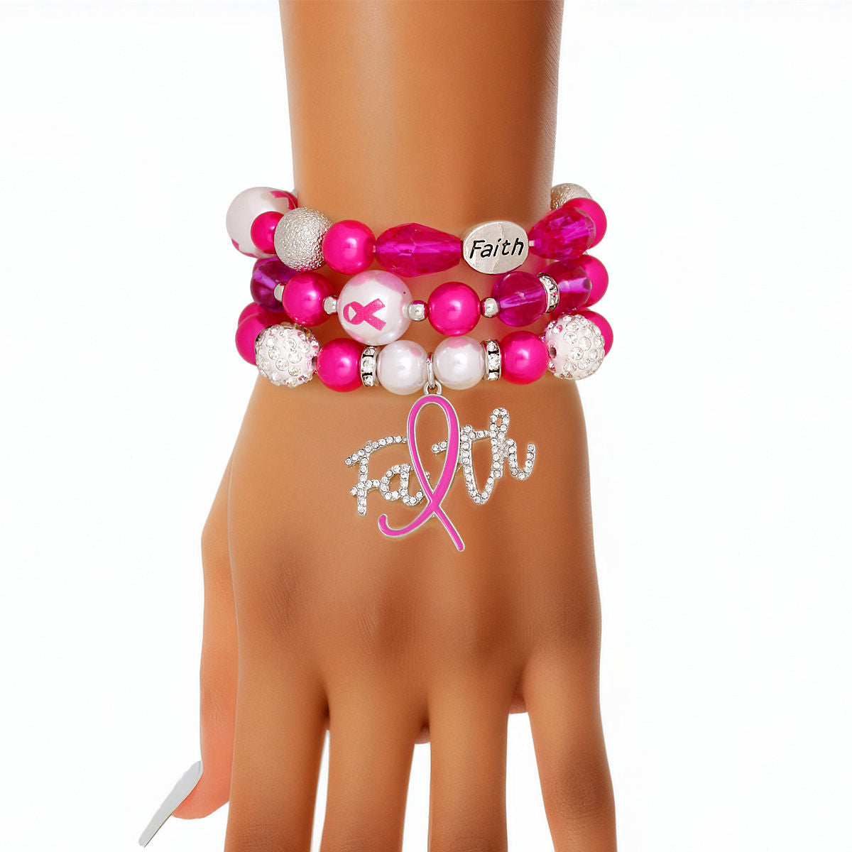 Fuchsia pink Faith charm bracelet set stacked on a woman's wrist, showing the rhinestone script Faith charm with pink ribbon "i", fuchsia teardrop glass beads and white rhinestone pavé beads⠋