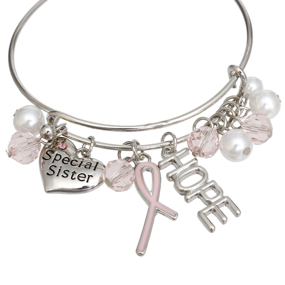 Close-up of light pink enamel awareness ribbon, cut-out HOPE letter charm and engraved Special Sister heart with pink rhinestone on silver bangle