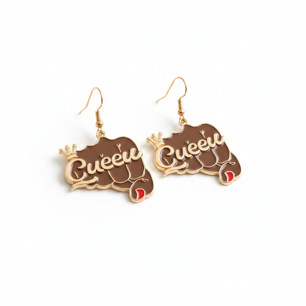 Pair of brown epoxy raised fist fish hook dangle earrings on white background, featuring gold-tone "Queen" script with crown accent, red nail detail, and gold fish hook wires