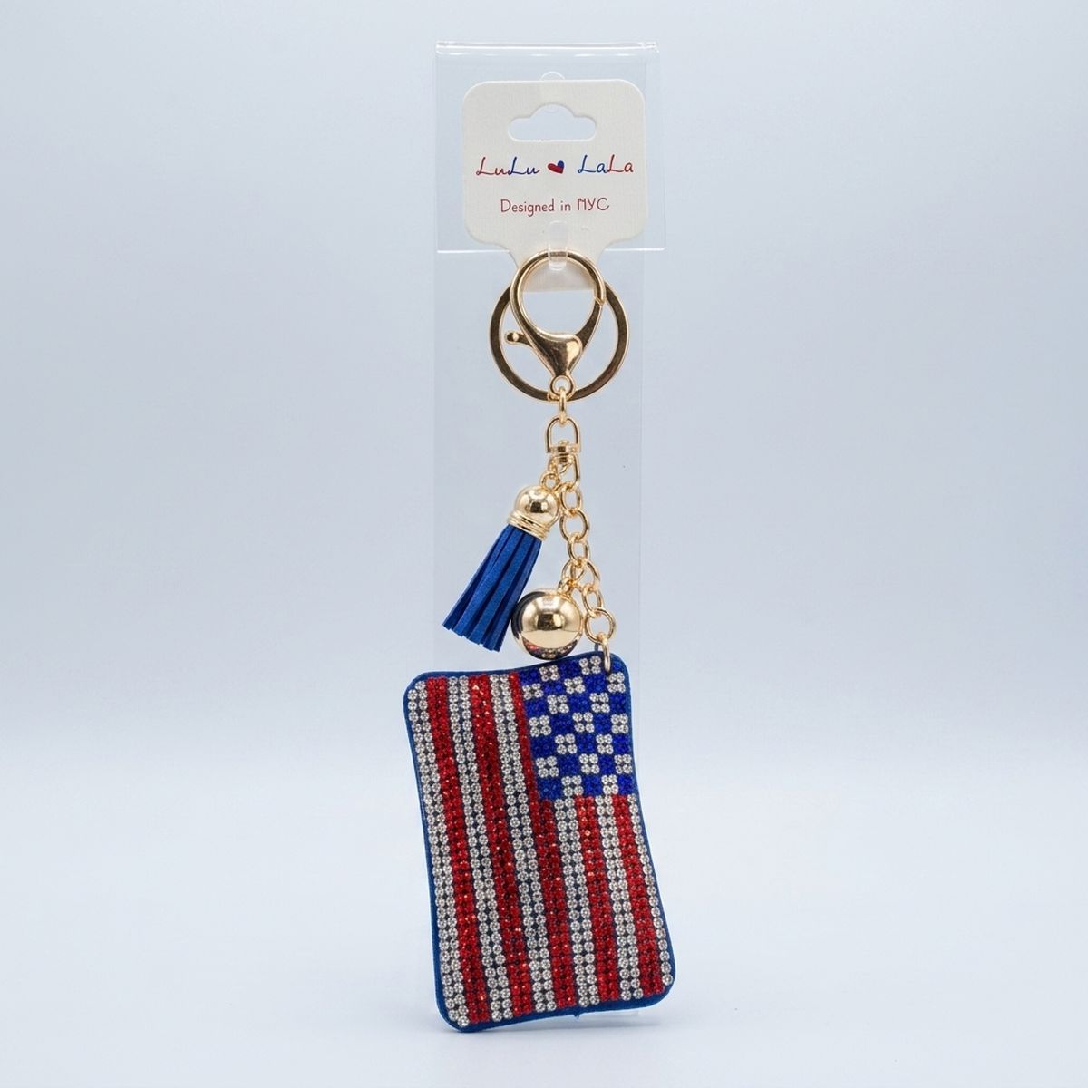 Patriotic flag rhinestone bag charm keychain with blue tassel and gold lobster clasp on white background