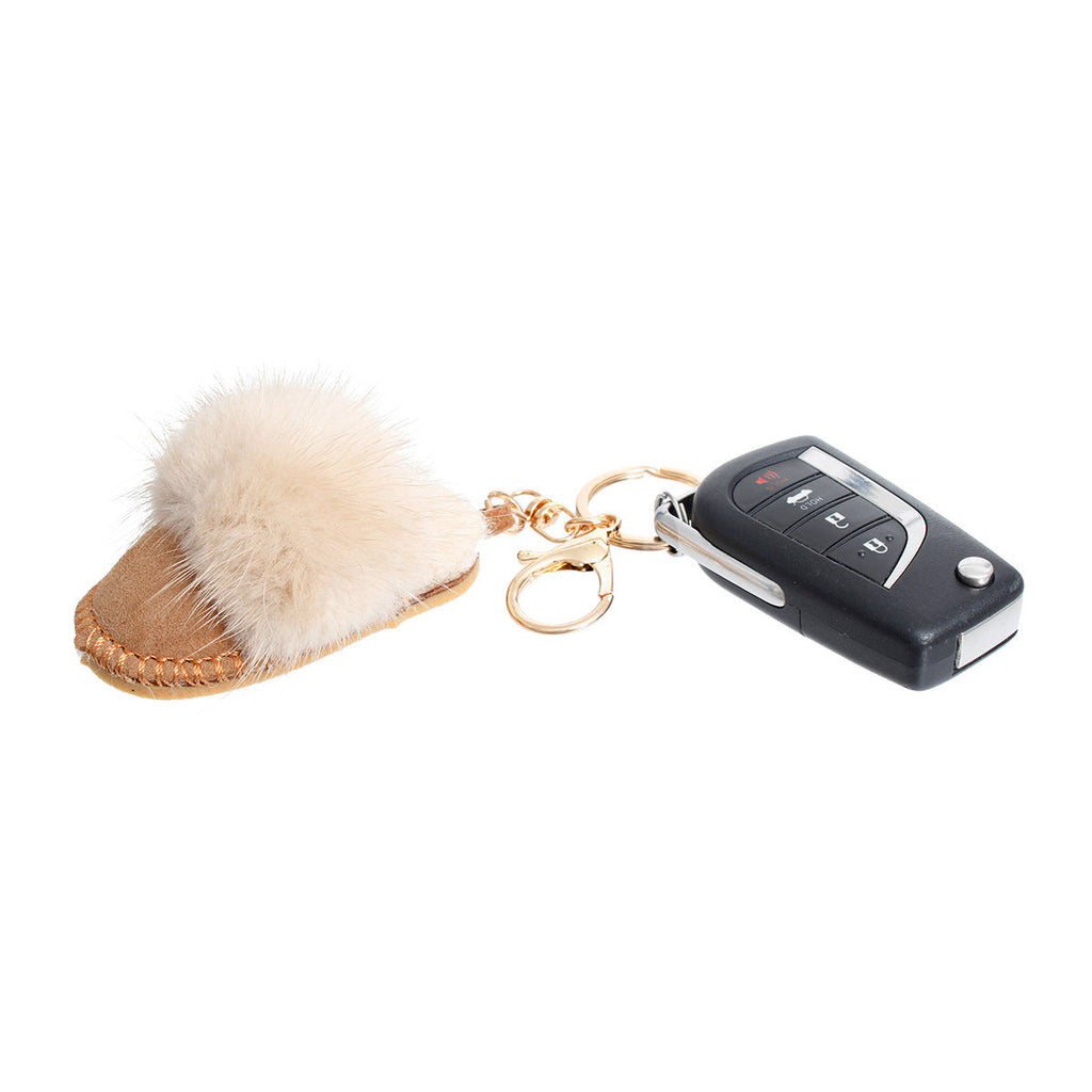 Light brown vegan suede mini mule slide bag charm keychain with cream faux fur pom-pom, gold split keyring, and gold lobster clasp