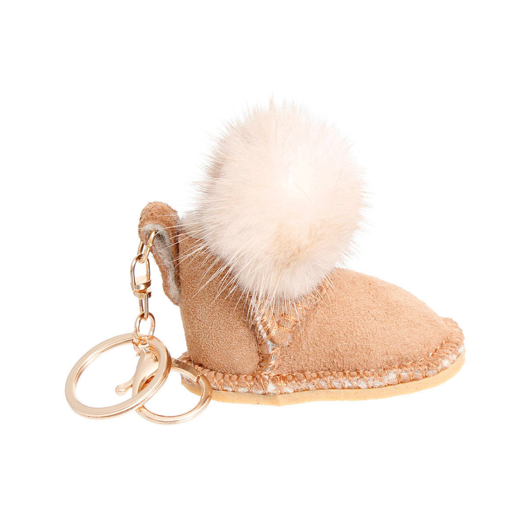 Light brown vegan suede mini boot bag charm keychain with white faux fur pom-pom cuff, stitched sole detail, gold keyring, and lobster clasp