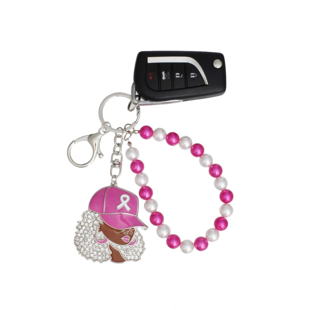 Breast cancer awareness pink cap woman keychain holding a car key fob, with silver key ring, swivel lobster clip and alternating fuchsia and white pearl wristlet loop