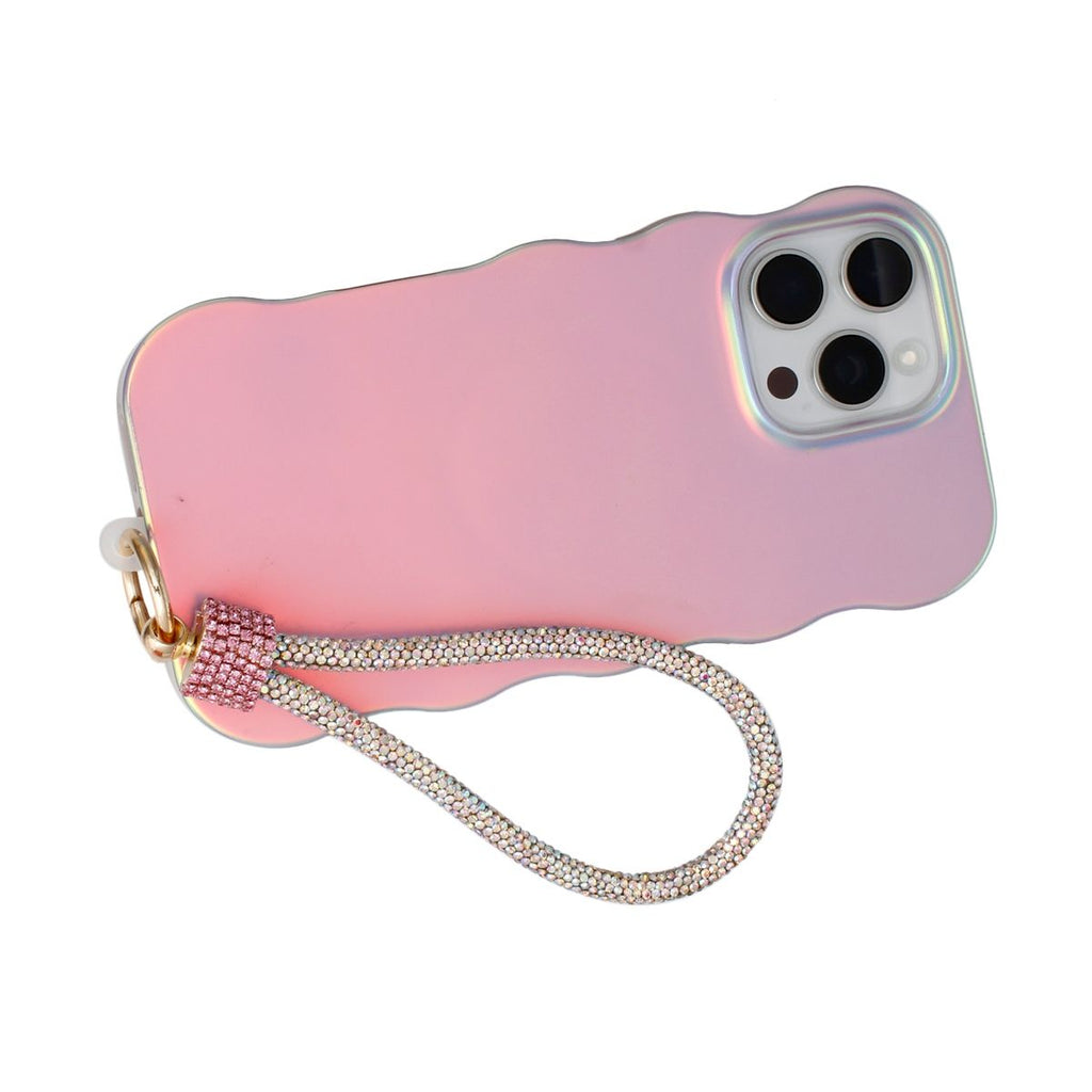 Pink aurora borealis rhinestone rope phone wrist strap attached to back of iridescent pink wavy-edge iPhone case via gold carabiner clasp and pink rhinestone barrel wrap, displayed on white background showing triple rear camera cutout