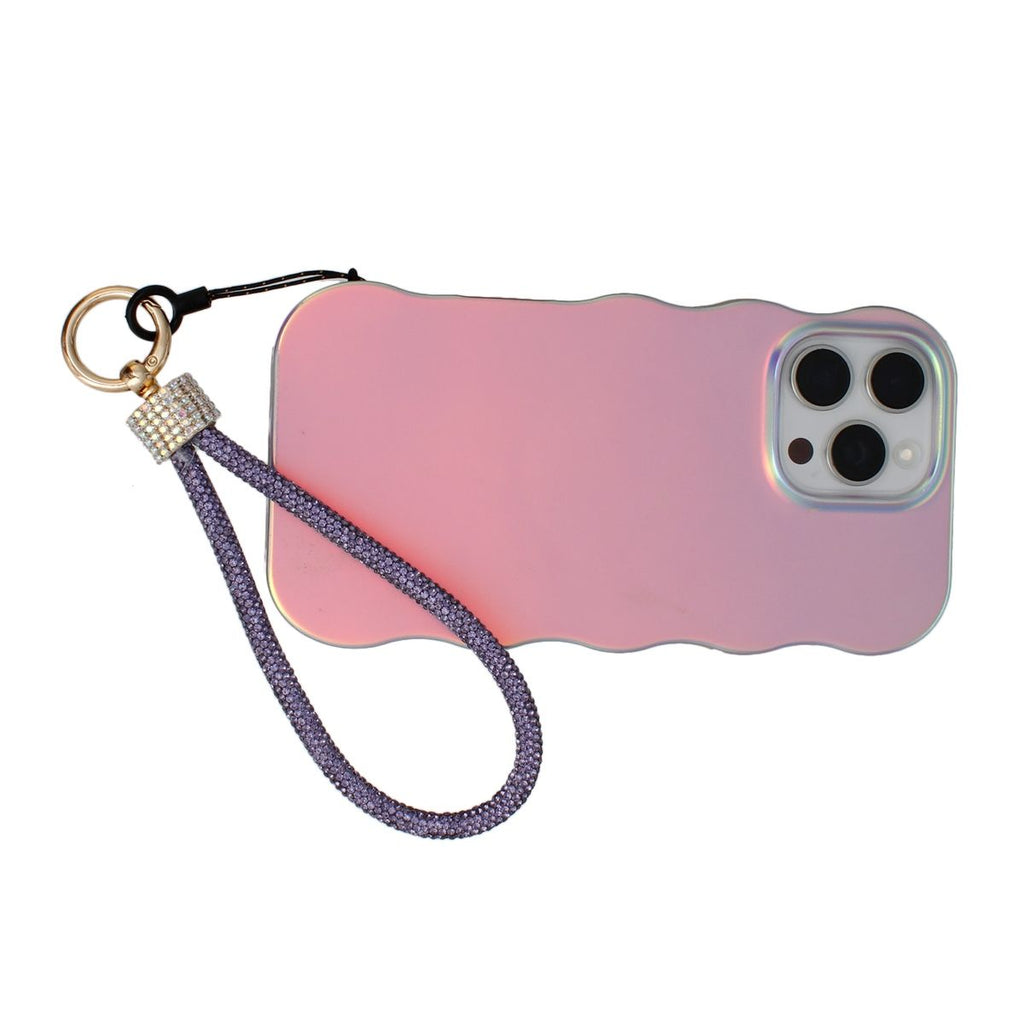 Purple rhinestone rope phone wrist strap looped around iridescent pink wavy-edge iPhone case with gold carabiner clasp, black cord loop, and clear rhinestone barrel wrap, displayed horizontally on white background showing triple rear camera cutout