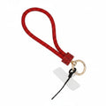 Red rhinestone-encrusted rope phone wrist strap on white background showing 10-inch loop, red rhinestone barrel knot wrap, round gold carabiner clasp, black cord loop, and clear plastic card insert