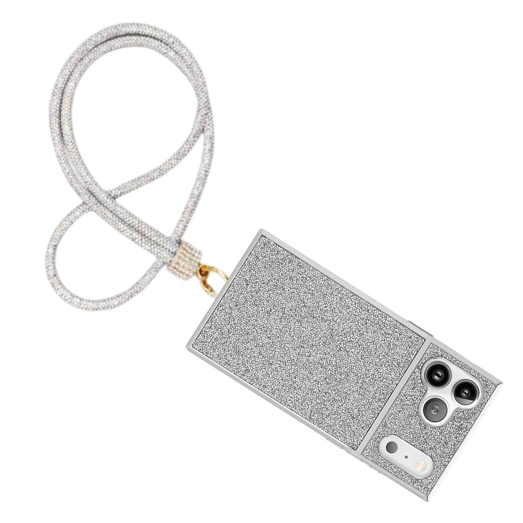Clear rhinestone-encrusted tube phone lanyard attached diagonally to full-coverage silver glitter hard-shell iPhone case with gold push clasp and clear rhinestone barrel slide, displayed on white background