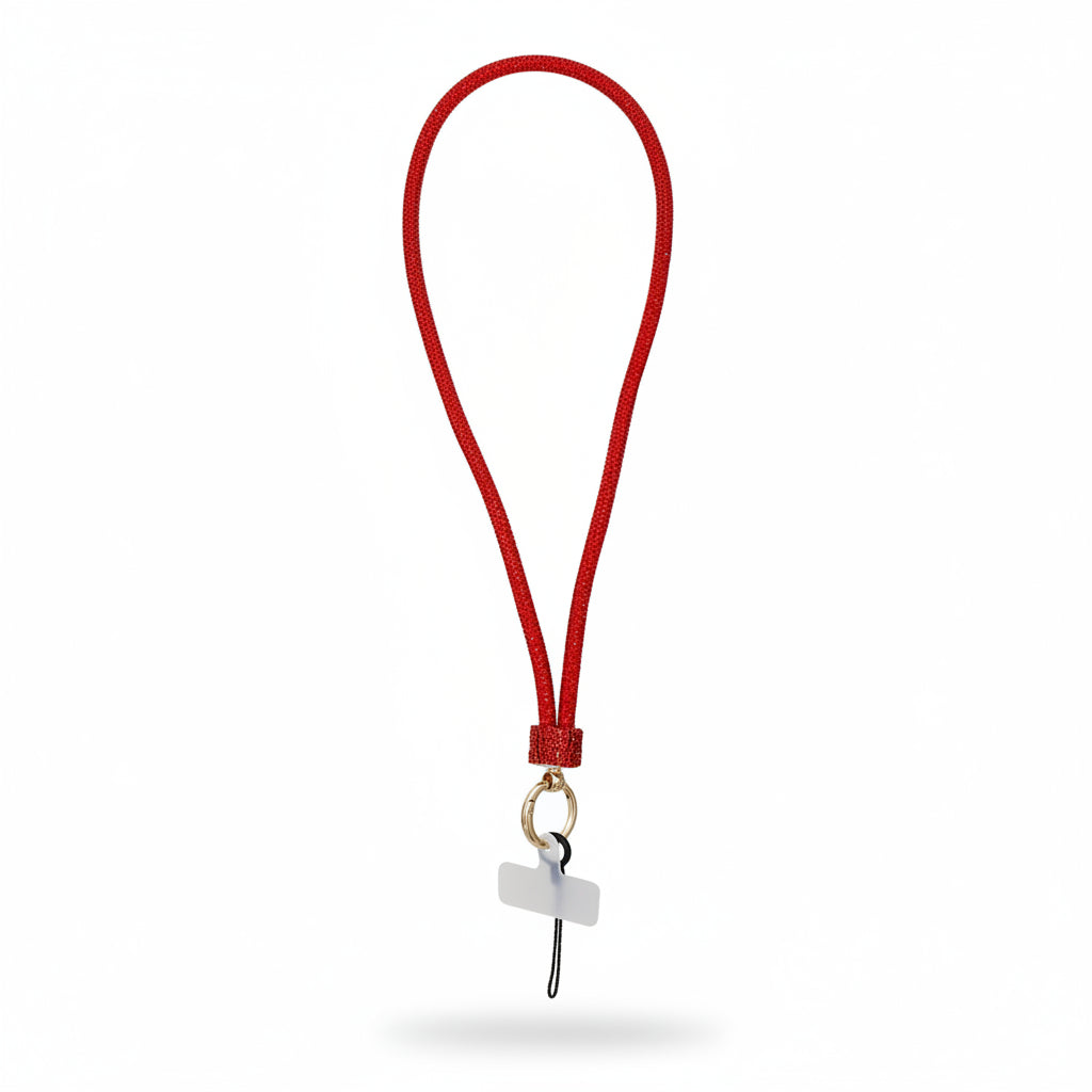 Red rhinestone-encrusted tube phone lanyard laid flat on white background showing full 32-inch loop, red rhinestone barrel slide, round gold push clasp, black jump ring, and clear rectangular plastic card insert