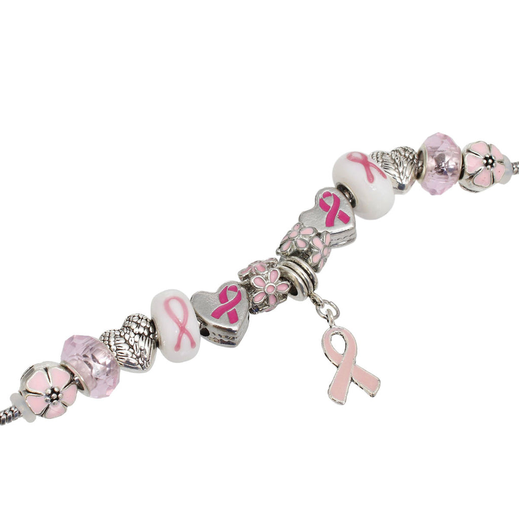 Close-up of pink ribbon heart slide beads, white ribbon beads, pink enamel flowers, angel wing hearts and light pink ribbon charm on a silver snake chain