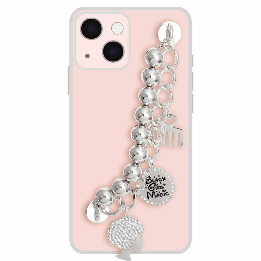 Silver Black Girl Magic phone wrist strap attached to pink iPhone case, featuring polished silver metal ball beads on silver curb chain, rhinestone afro woman silhouette charm, round Black Girl Magic engraved disc charm with rhinestone border, and silver afro pick comb charm
