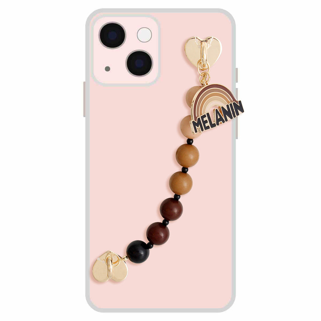 Brown Melanin phone wrist strap attached to pink iPhone case, featuring gradient brown-to-black round acrylic beads, small black spacer beads, gold heart clasp hardware, and brown enamel rainbow charm with black MELANIN text