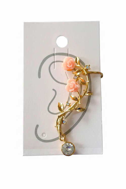 Gold floral vine ear cuff with two pink rose cabochons, gold leaf vine, iridescent crystal accents, and round clear rhinestone drop charm displayed on white jewelry card