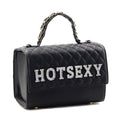 Black structured satchel with a diamond-quilted flap, rhinestone HOTSEXY lettering, smooth lower panel, and gold-chain-accented top handle on a white background