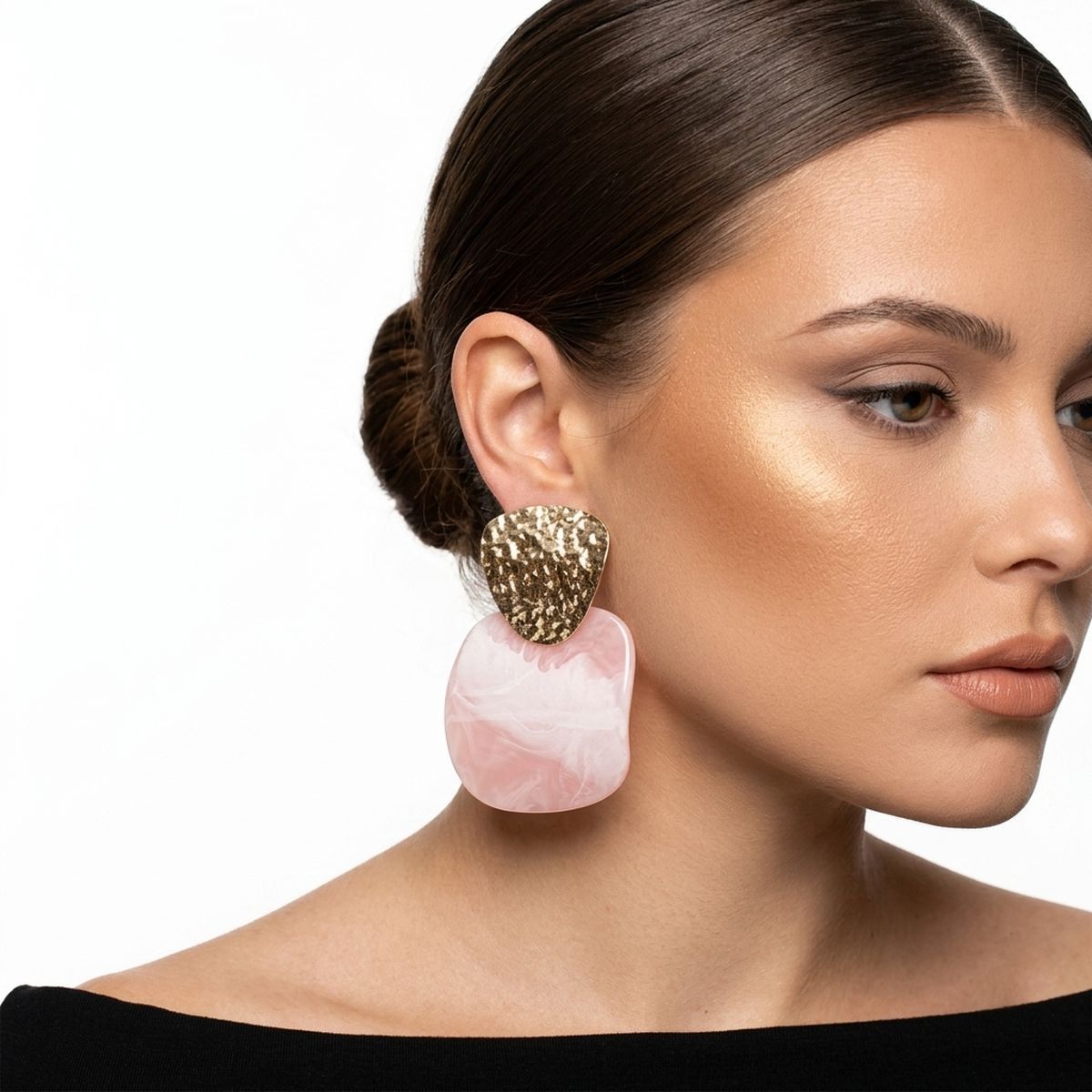 Model wearing oversized light pink resin drop earrings with textured gold-tone tops