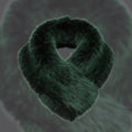 Emerald green faux fur collar scarf arranged in a loop with crossed rounded ends on a dark background, showing its plush fibers and dark shading