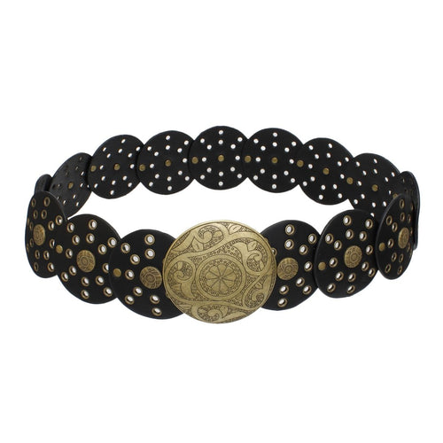 Black vegan faux leather wide western concho belt laid flat on white background, overlapping circular disc panels with gold grommet and rivet punch-out details, large engraved distressed gold round concho buckle with floral and paisley etching at center