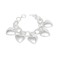 Women's silver-tone chunky heart charm toggle bracelet laid flat showing circle-and-bar toggle closure and five large hollow puffy heart charms dangling from double oval link chain, white background