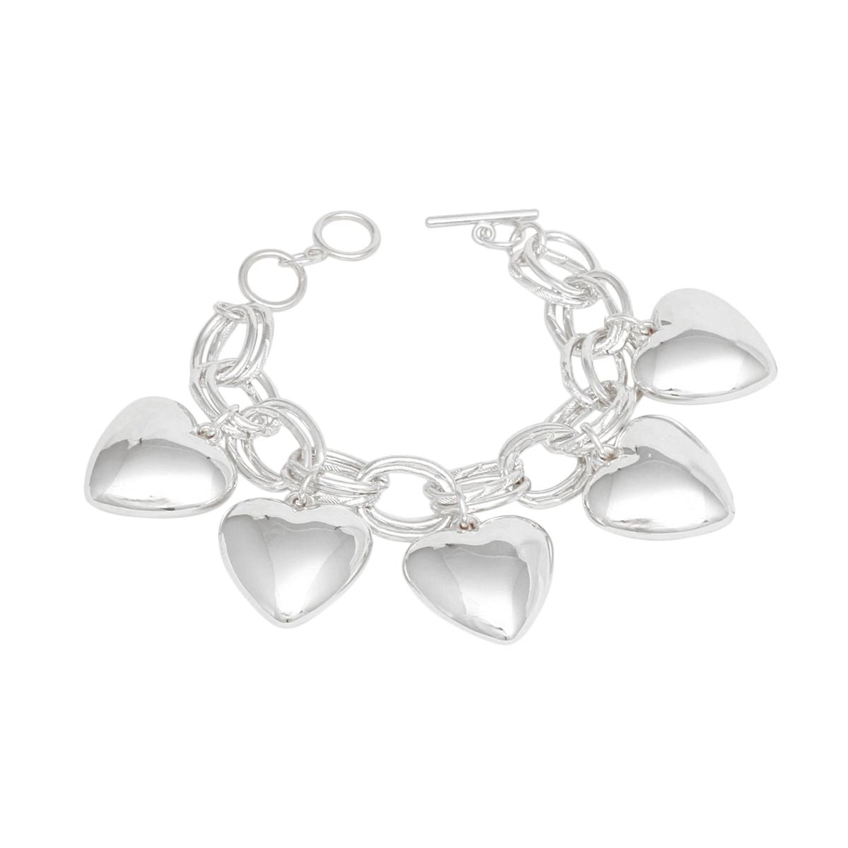 Women's silver-tone chunky heart charm toggle bracelet laid flat showing circle-and-bar toggle closure and five large hollow puffy heart charms dangling from double oval link chain, white background