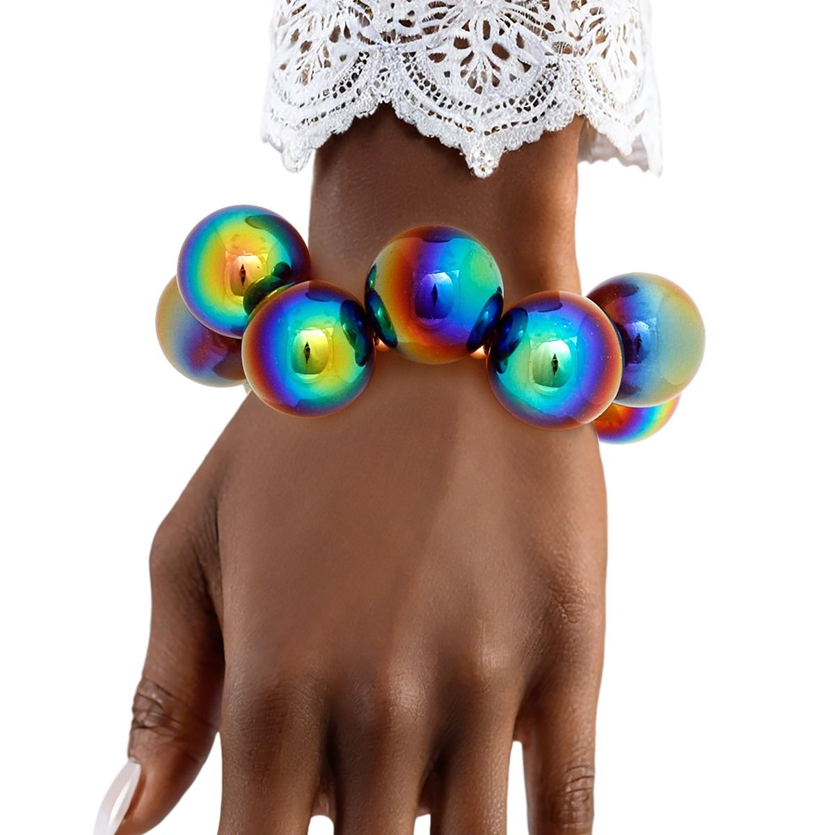 Rainbow iridescent bubble bead bracelet worn on a wrist beneath a white lace cuff against a white background