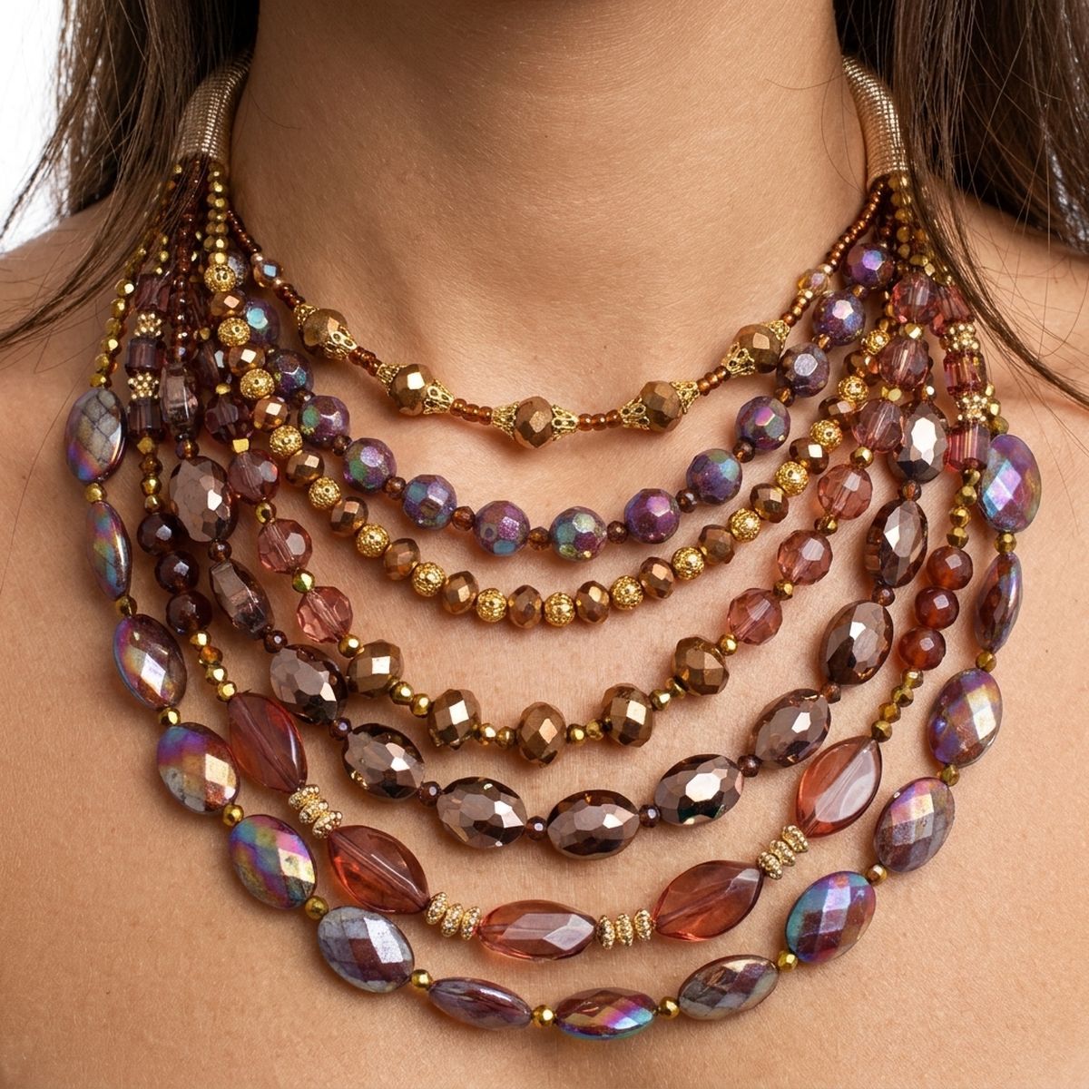 Close-up of a multi-strand crystal bib necklace with faceted brown, purple, bronze, and champagne beads