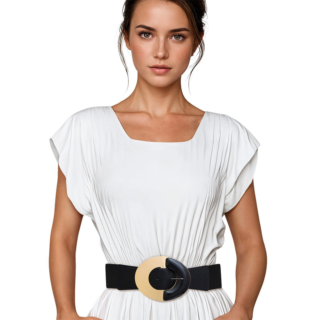 Black wide stretch belt worn on woman's waist over white pleated short-sleeve dress, oversized round two-tone buckle with gold metal half-circle and black acrylic half-circle with pin closure, black elastic stretch back panel, white background