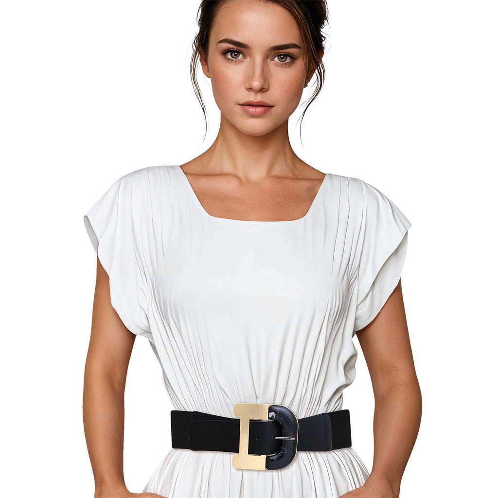 Black wide stretch belt worn on woman's waist over white pleated short-sleeve dress, oversized two-tone buckle with gold metal rectangular frame and black marbled acrylic center insert, black elastic stretch back panel, white background