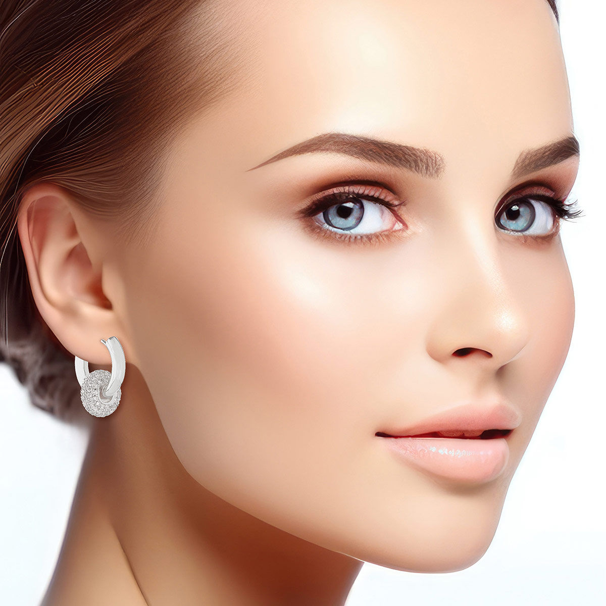 Woman wearing 14K white gold plated huggie hoop earrings styled without the pavé ring charm, showing the sleek polished silver-tone hoop alone, white background, hair pulled back in updo