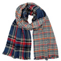 Reversible scarf loosely looped on a white background, displaying navy-and-red plaid beside cream-and-navy houndstooth with red and orange lines and multicolor fringe
