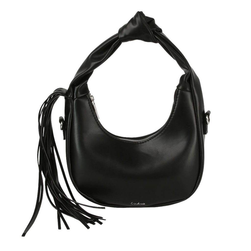Front view of a black rounded faux-leather shoulder bag with a knotted handle, curved silver-tone zipper and long fringe hanging from one side, on a white background