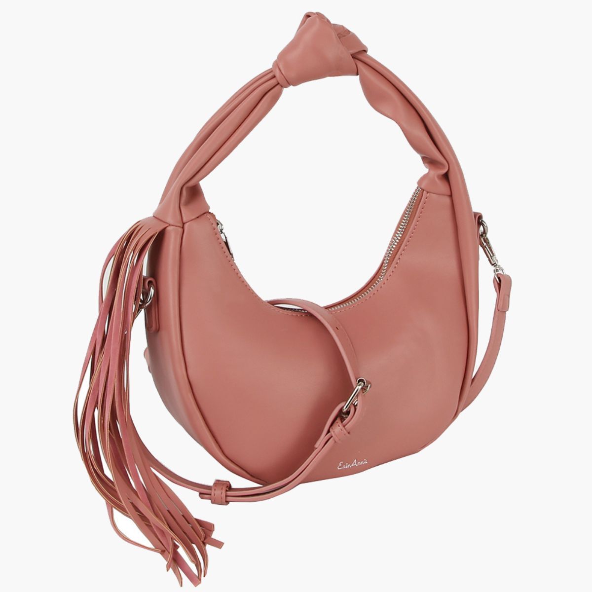 Blush pink crescent handbag with a detachable adjustable strap draped across the front, knotted handle, and long side tassel