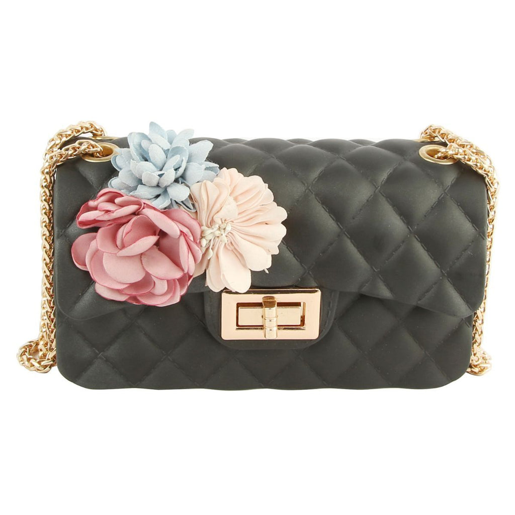Front view of black diamond-quilted jelly bag with pink, pale blue, and cream flower appliqués, a gold-tone twist lock, and chain strap on a white background