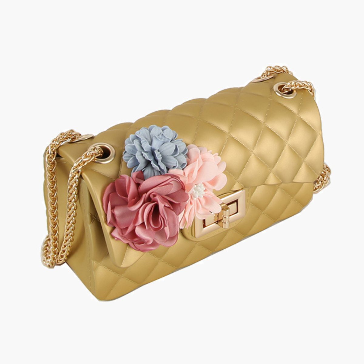 Angled view of a glossy gold quilted jelly flap bag with three fabric flowers in dusty rose, blush, and powder blue, a gold twist lock, and a woven gold chain strap