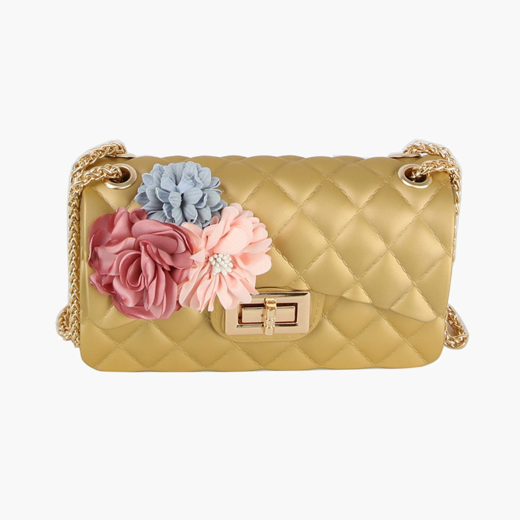 Front view of the gold quilted jelly bag showing the diamond quilting, the flower cluster on the left of the flap, the gold twist lock, and chain straps threaded through gold grommets