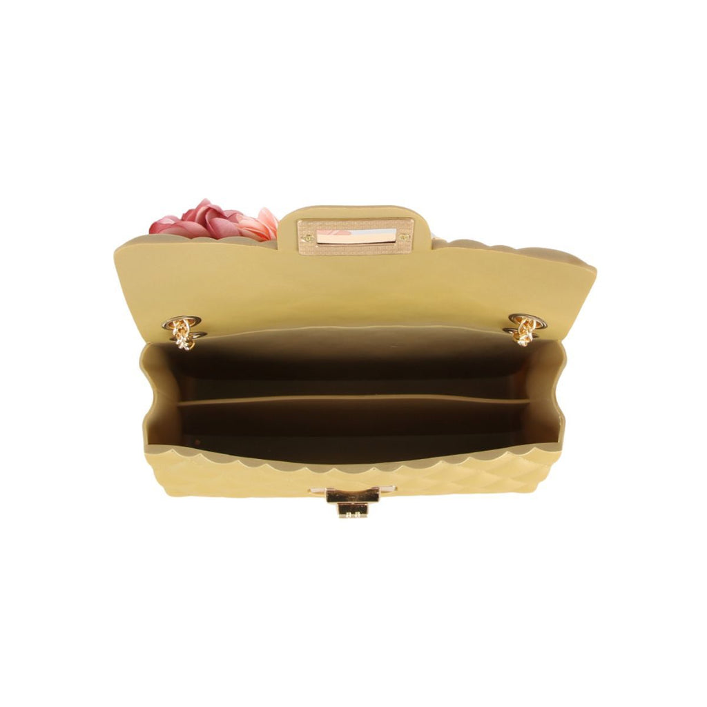 Overhead view of the bag open, showing the pale gold divided interior with two compartments and the gold twist lock hardware on the flap