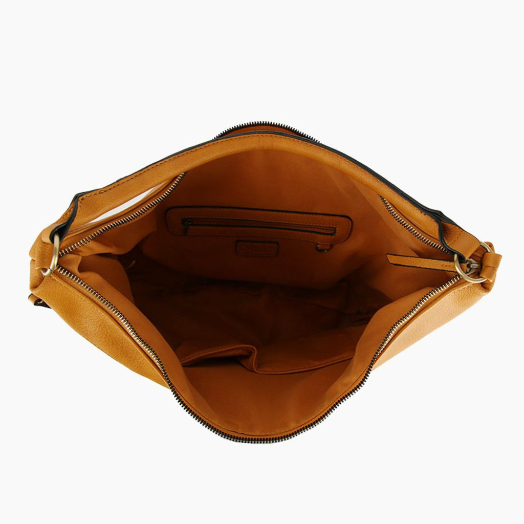 Open mustard yellow handbag showing its lined interior, interior zipper pocket, slip pockets, and main zipper opening