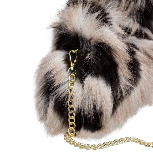 Close-up of the cream-and-black faux-fur bag showing its gold-tone chain clasp attached at the side