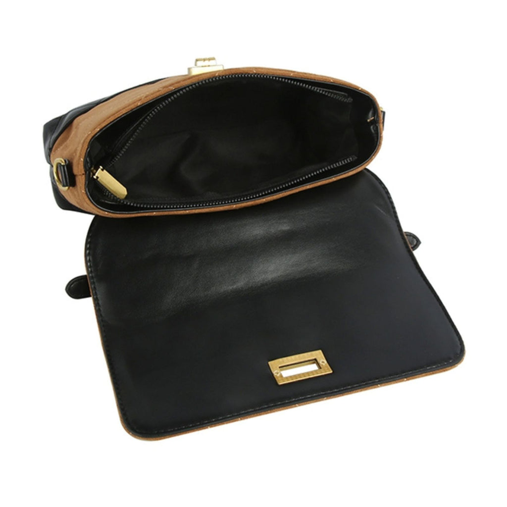 Interior view of the brown and black quilted top handle bag, unzipped and flap open, showing the black lined interior with a side zipper pocket and gold zipper pull