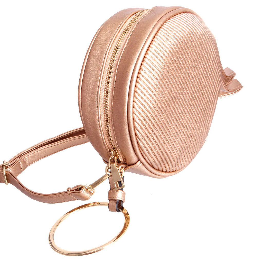 Rose gold vegan leather ribbed circle crossbody wristlet with gold metal circle detailing, zipper closure, and detachable matching shoulder strap