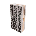 Closed rectangular hardcase clutch with a black-and-silver rhinestone Greek-key pattern, gold-tone frame and push lock on a white background