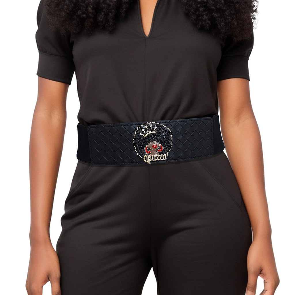 Black wide woven vegan leather stretch belt worn on woman's waist over dark olive V-neck short sleeve jumpsuit, rhinestone Afro Queen medallion at center with black crystal afro, rhinestone crown, red enamel hoop earrings, and gold Queen script lettering, white background