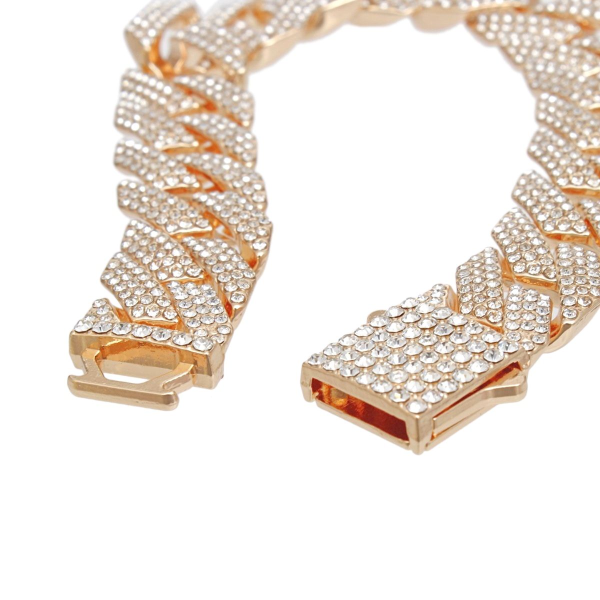 Close-up detail shot of the push-lock box clasp on a gold tone fully pave clear rhinestone Miami Cuban chain bracelet. The clasp is open showing the two-piece rectangular rhinestone-covered lock mechanism with gold metal prong guides and clear rhinestone detailing.