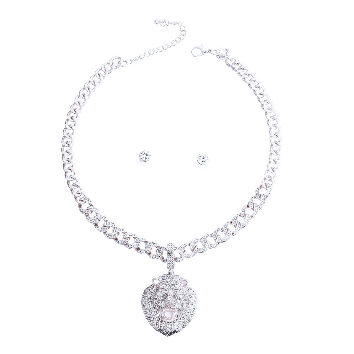 Full set on white background — rhinestone-encrusted silver Cuban link chain necklace with a large 3D rhinestone-covered lion head pendant, lobster clasp and extender chain visible, with two small round clear rhinestone stud earrings centered inside the necklace