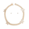 Gold rhinestone butterfly Cuban chain necklace set with matching small pearl stud earrings, flat lay on white background, push-lock clasp open
