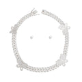 Silver rhinestone butterfly Cuban chain necklace set with matching small round stud earrings, flat lay on white background, push-lock clasp visible