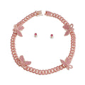 Pink rhinestone rose gold butterfly Cuban chain necklace set with matching pink crystal round stud earrings, flat lay on white background, push-lock clasp open