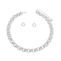 Overhead flat lay of a chunky silver rhodium tone triple ring rolo chain choker necklace arranged in a circle on a white background. Each link features three interlocking rings with two polished and one ribbed textured ring. A lobster clasp closure and 3-inch extender chain with small oval links and a round hang tag are visible at the top. Two small open circle ring stud earrings with ribbed texture and post backings are displayed inside the necklace loop.