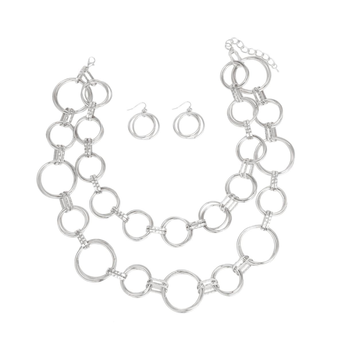 Full set laid out on white background — double layer chunky silver ring link necklace with mixed small and large open circular rings connected by rectangular hammered barrel links, lobster clasp and extender chain visible, with two matching small circular fish hook earrings centered between the necklace layers