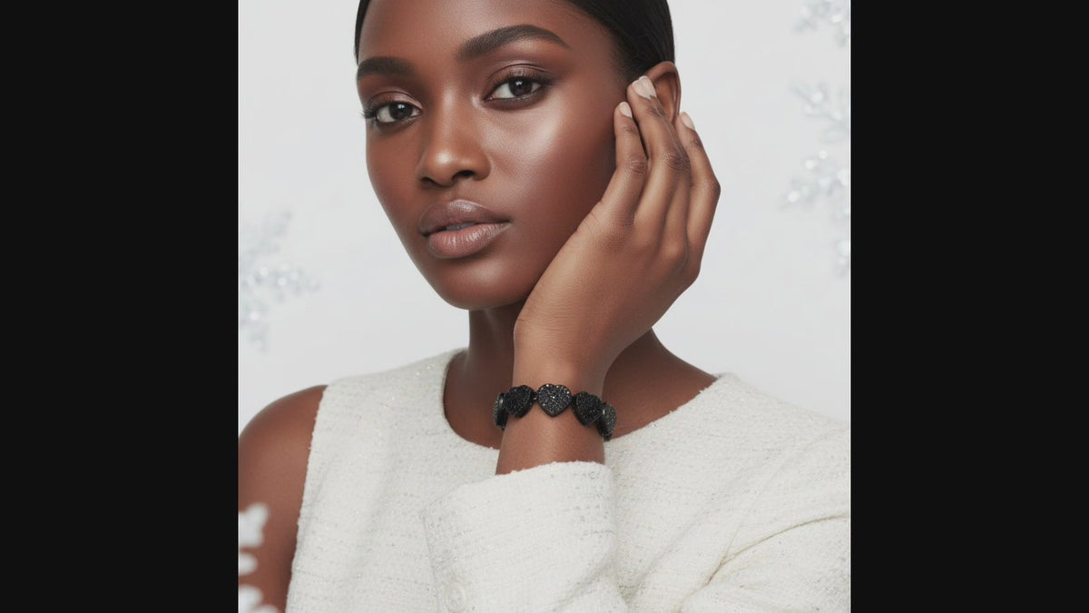 Video showing a jet black coated chain bracelet with black pavé heart links and a bold statement design.