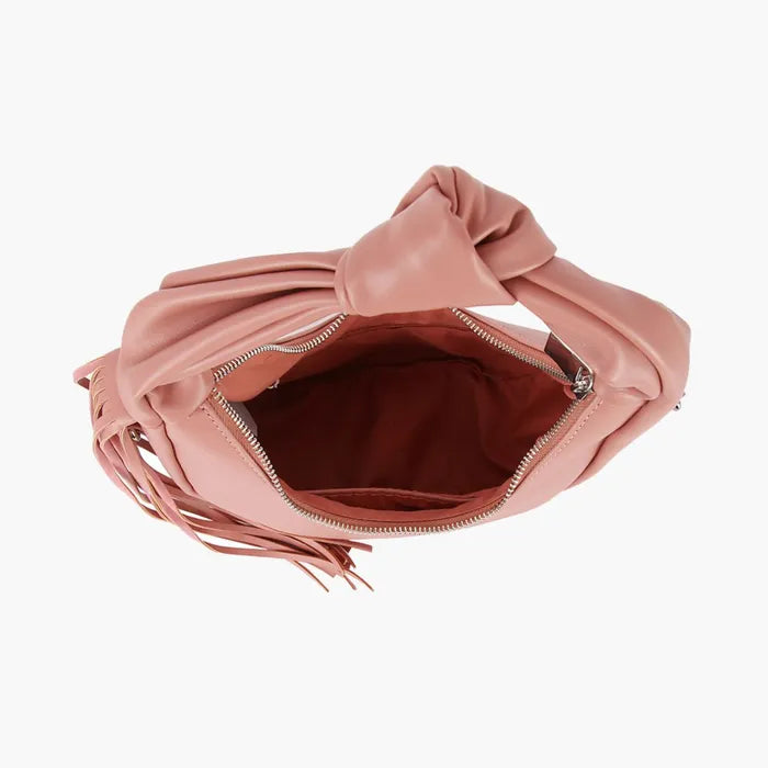 Top view of an open blush pink handbag showing its lined interior, zipper opening, knotted handle, and side fringe